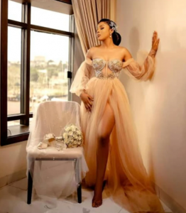 dark skin woman with vintage look in long nude color boudoir dress