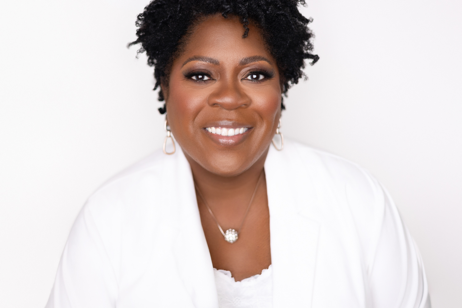 atlanta headshot photo of african american woman wearing white outfit on white background by Laquel Wright Photography